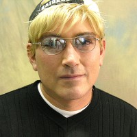 Unsmiling blond man with glasses