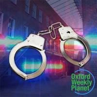 Handcuffs with police lights and an office building in the background and the Oxford Weekly Planet logo in the foreground