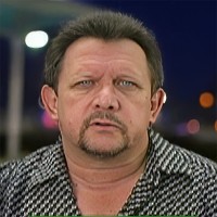 Rugged-looking man with dark hair, mustache and goatee