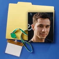 Manila folder with badge holder and lanyard with a photo of a young man with short dark hair