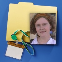 Manila folder with badge holder and lanyard with a photo of a young woman with short wavy hair