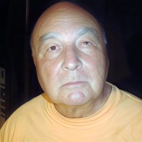 Bald older man with gray eyebrows