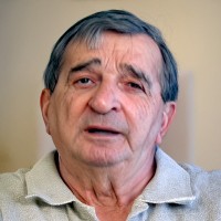 Older man with dark, graying hair