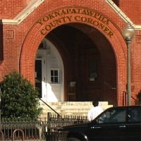 Photo of the entrance to the red brick building that houses the Yoknapatawpha County Coroner's Office