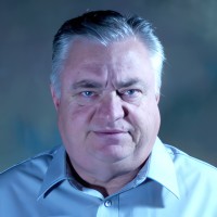 Unhappy-looking man with short salt-and-pepper hair