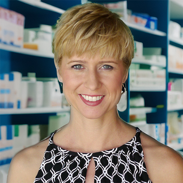 Woman with a blonde pixie haircut in a pharmacy