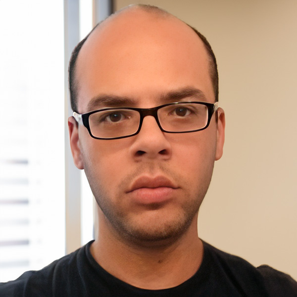 Unsmiling balding man with glasses