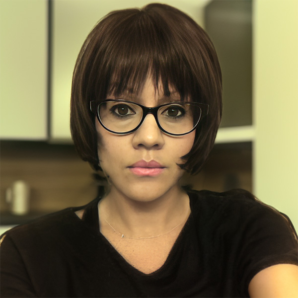 Woman with a short, dark bob and dark-rimmed glasses