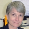 Smiling woman with a salt-and-pepper pixie cut