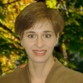 Smiling woman with short brown hair and brown eyes