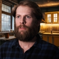 Man with dark blond hair and a heavy beard