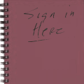 Photo of spiral-bound notebook with "Sign in here" written on the cover