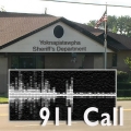 Exterior of the sheriff's department with an audio graph in the foreground