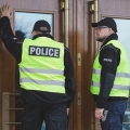 Uniformed police officers knocking on a residence door