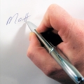 hand with pen writing name