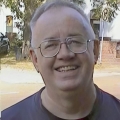 Older man with glasses and thinning gray hair