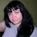 Young woman with dark hair and bangs