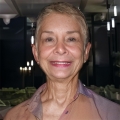 Smiling older woman with a gray-blonde pixie cut