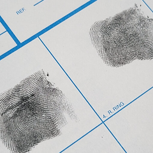 Inked fingerprints on a white fd-258 applicant card